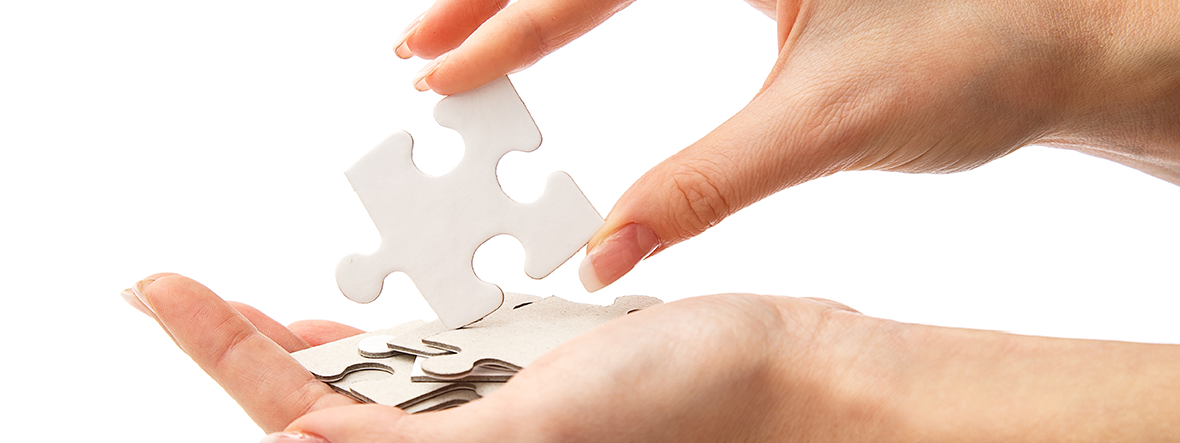 female hands holding white puzzle tassels